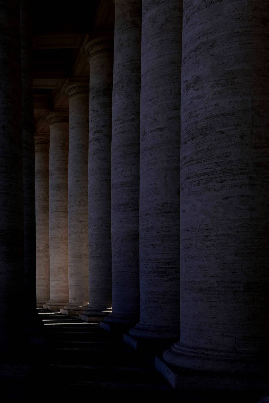 pillar a row of columns with a clock on the top of one of them column picture