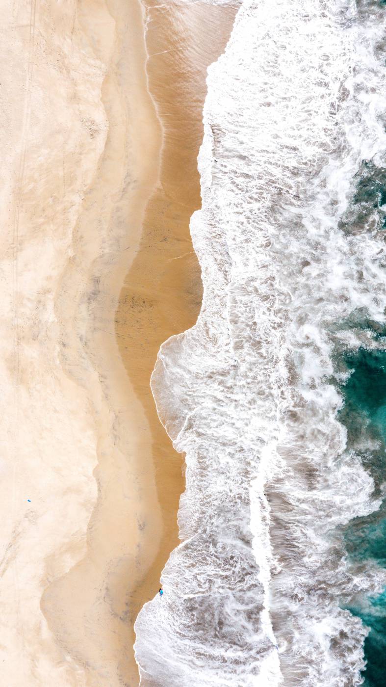  aerial view of ocean waves crashing on shore during daytime  picture