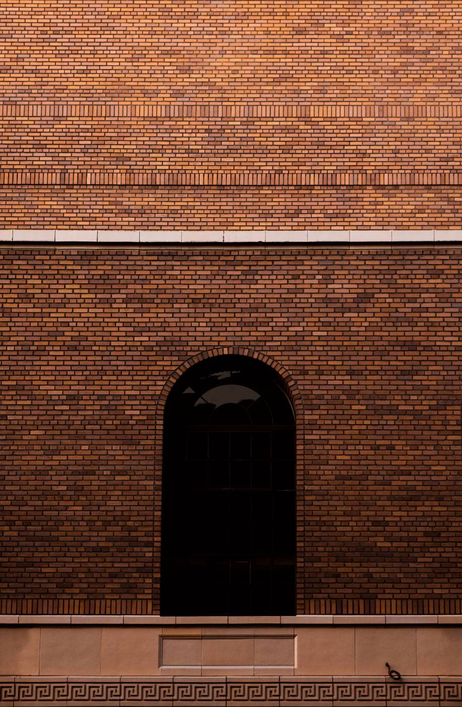  brown brick wall with black window  picture