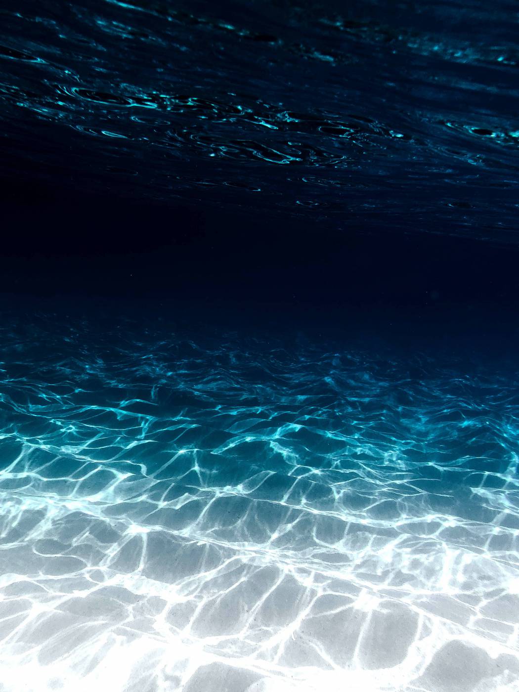 grey sand under blue clear water picture