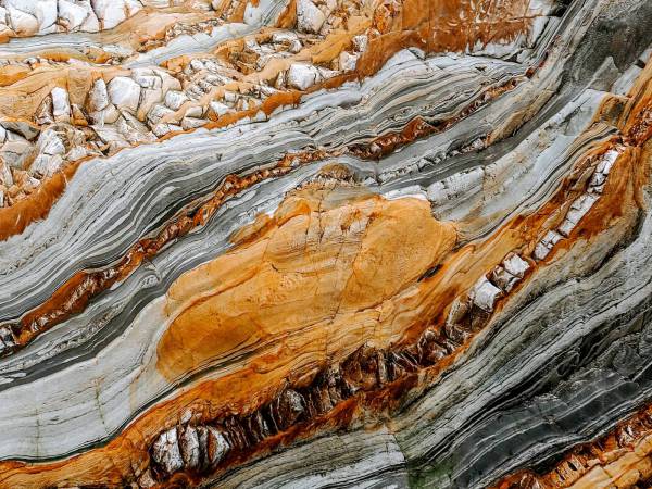  close-up photography of gray and orange stones 