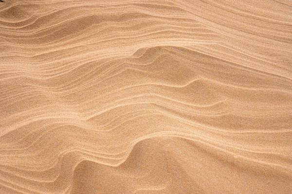 texture brown sand with shadow of person 